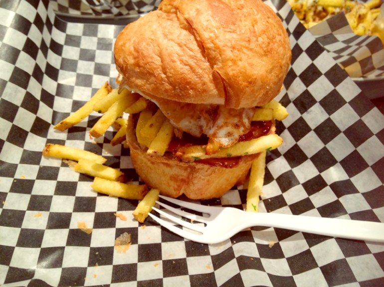 Fork in photo is unrelated to burger eating.